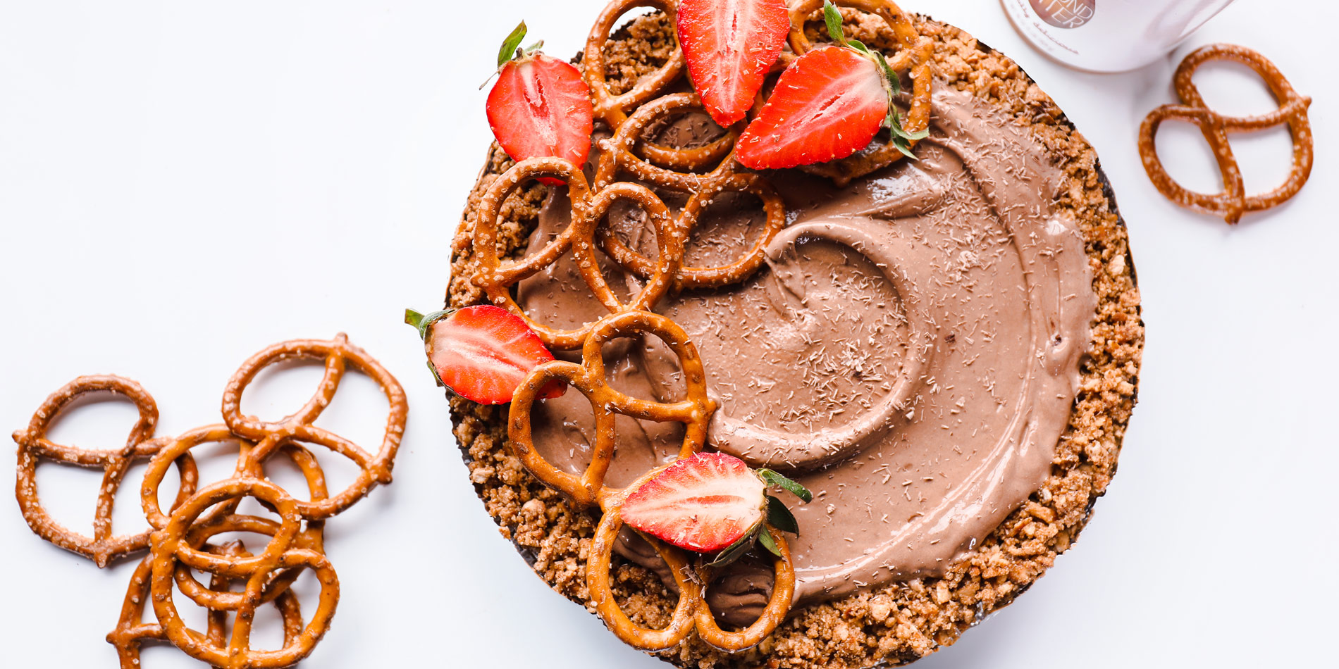 Chocolate Mousse Pie with No Bake Pretzel Almond Butter Pie Crust with strawberry toppings in the white background