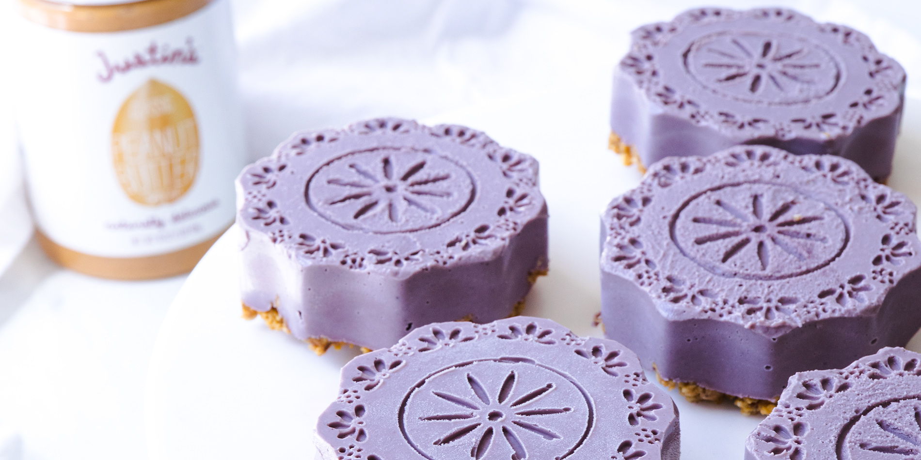 Plant-Based Peanut Butter Blueberry Cheesecakes (close up) placed on a white background