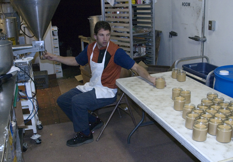 Justin sitting on chair, producing Justin's peanut butter products