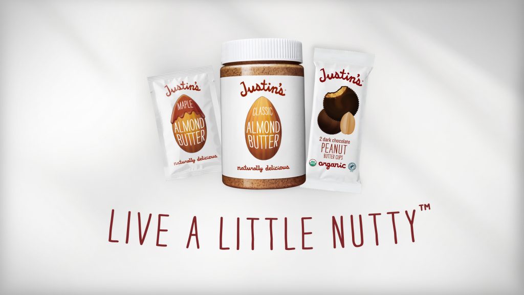 Homepage pop up with Justin's Maple Almond Butter squeezepack, Classic Almond Butter jar, and Dark Chocolate PB Cups with text "Live A Little Nutty" at the bottom