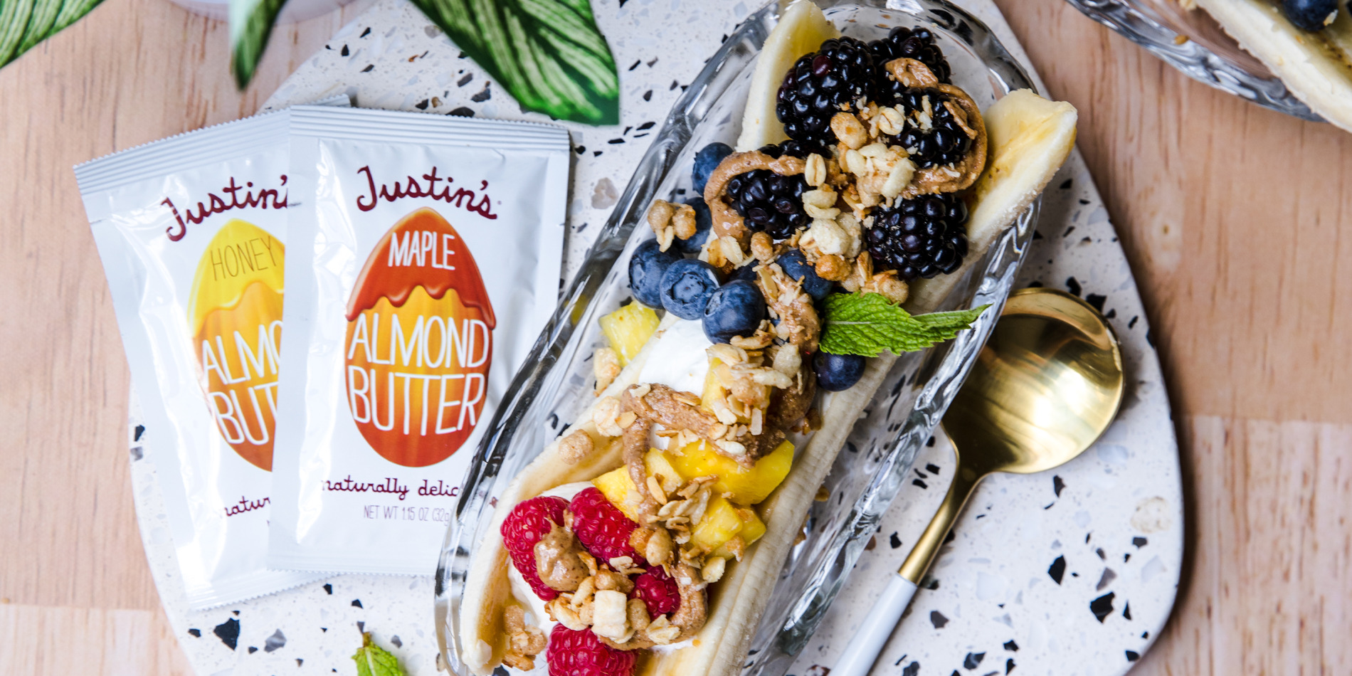 Banana split with peanut butter, fruit and granola on top.