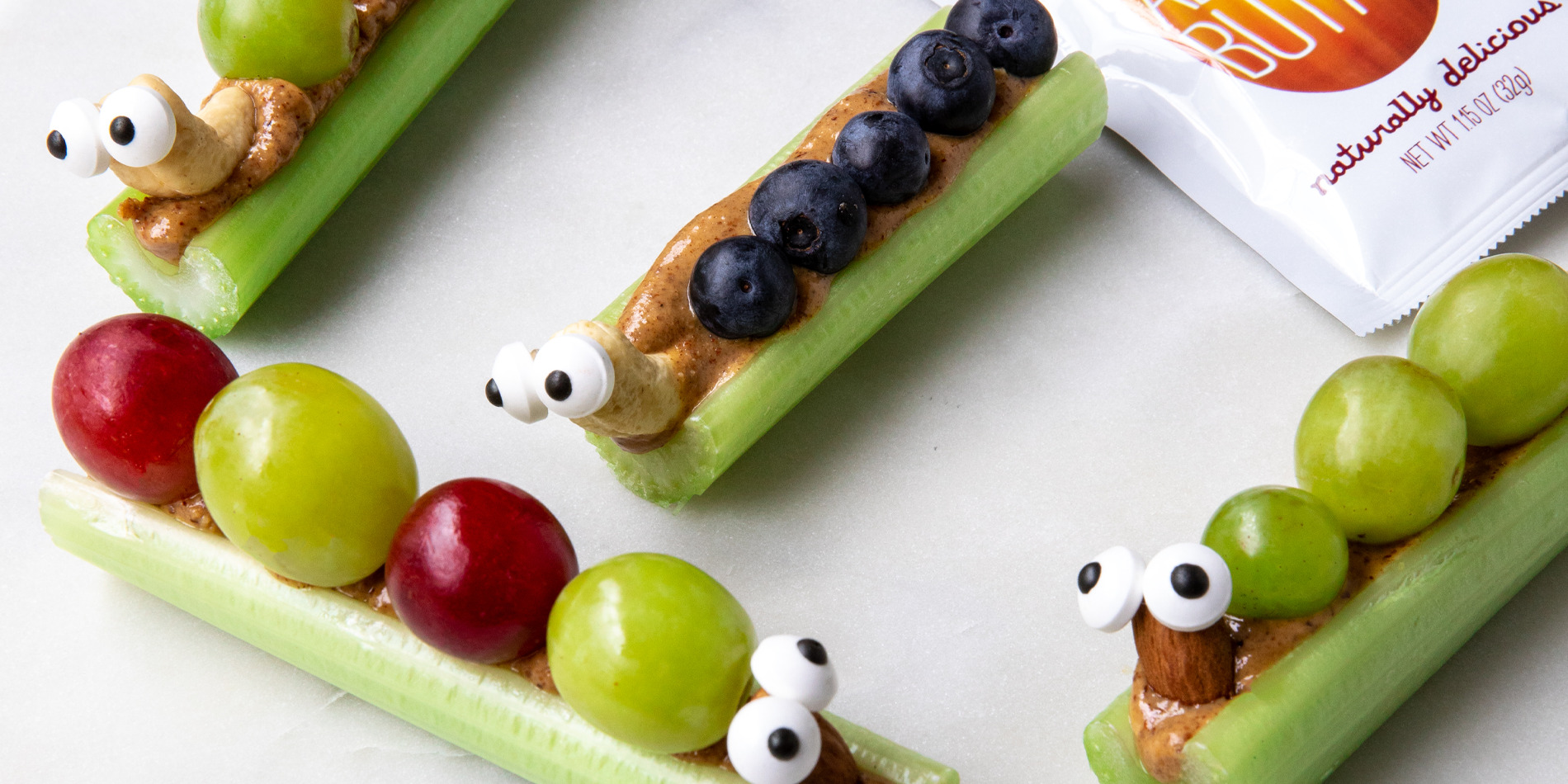 Celery sticks with peanut butter, grapes and blueberries on top.